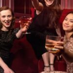 Athletic Textiles - Women drinking whisky cocktails in a bar or nightclub