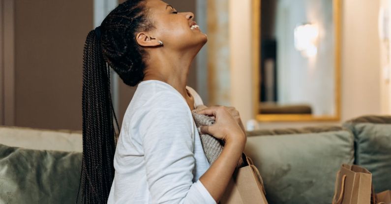 Biodegradable Fabrics - Woman Hugging a Fabric From a Paper Bag