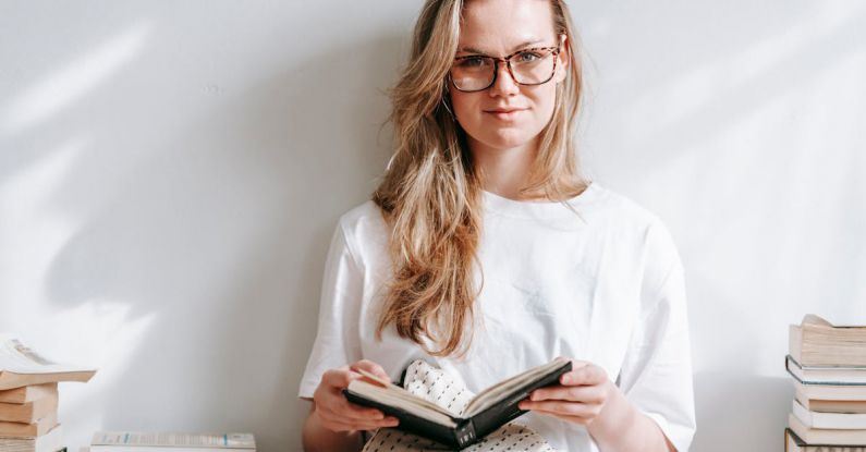 Smart Textiles - Smiling student with agenda between books in house