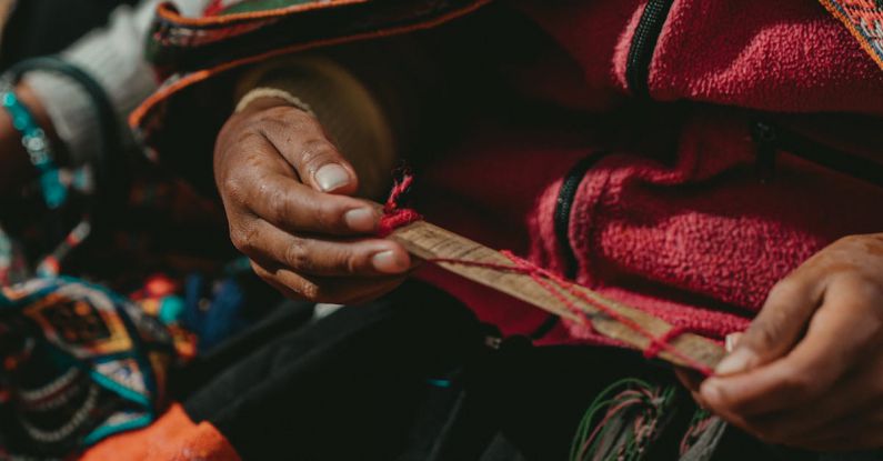 Temperature-Regulating Fabrics - A woman in traditional clothing is holding a piece of cloth