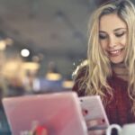 Beauty Devices - Woman in Red Sweater Holding White Cellphone