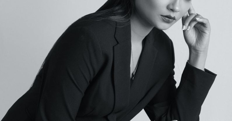 Professional Make-Up - A woman in a black suit kneeling down