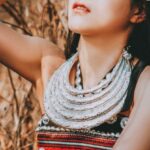 Statement Jewelry - A woman in traditional clothing and headdress