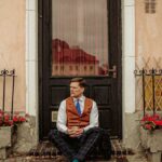 Vintage Styles - A man sitting on a bench in front of a building
