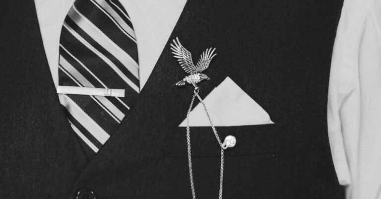 Vintage Wedding Dresses - Unrecognizable bearded man in white shirt tie and elegant waistcoat with brooch and chain