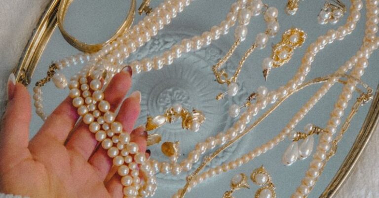 Vintage Accessories - Person Holding a Pearl Necklace on Silver Tray