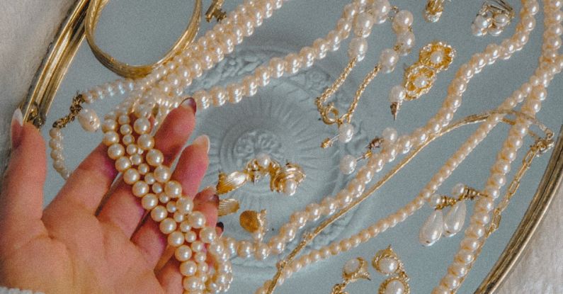 Vintage Accessories - Person Holding a Pearl Necklace on Silver Tray