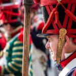 Military Uniforms - A man in a military uniform holding a stick
