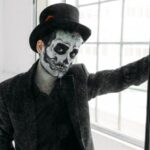Traditional Wedding Attire - Man in Black Coat Standing Beside A Mirror