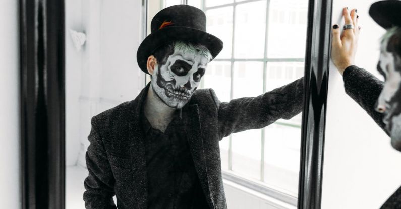 Traditional Wedding Attire - Man in Black Coat Standing Beside A Mirror