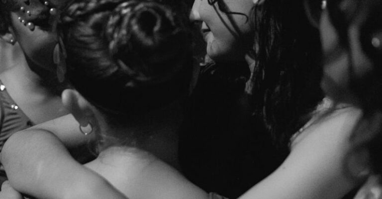 Headdresses - Women Hugging During a Concert