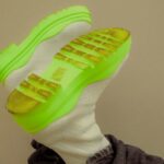 Footwear Fashion - A person wearing neon green sneakers